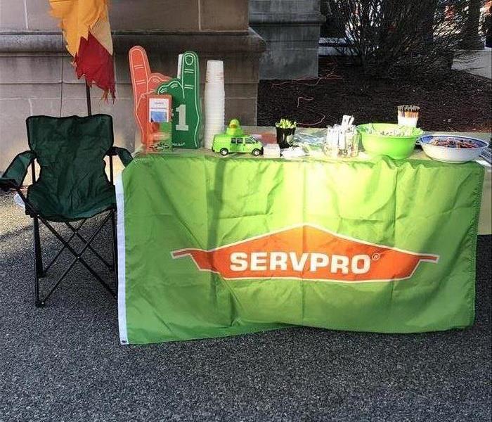 SERVPRO table with flag, foam fingers, and candy 